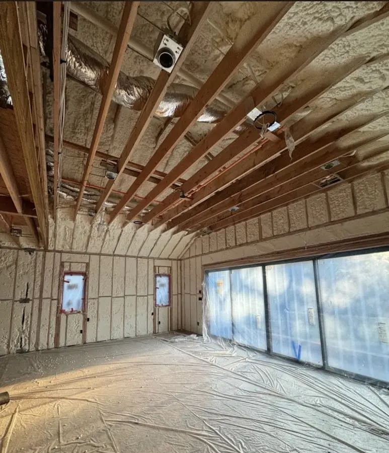 Interior walls and ceiling insulated with spray foam during new construction in Baldwin City
